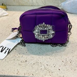 A Zaras NWT purple mini bag with crystals in the front.